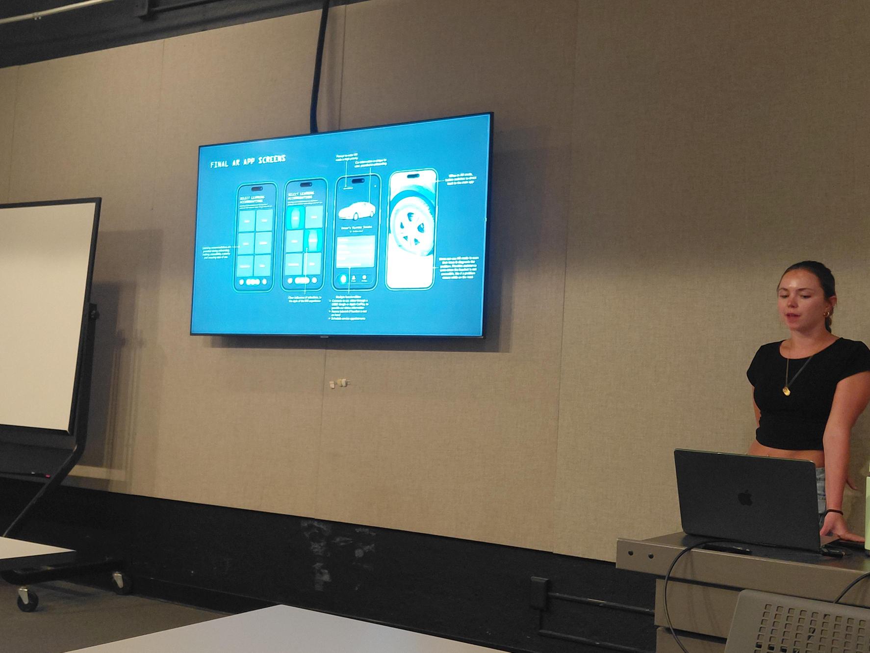 Student presenting final AR app screens