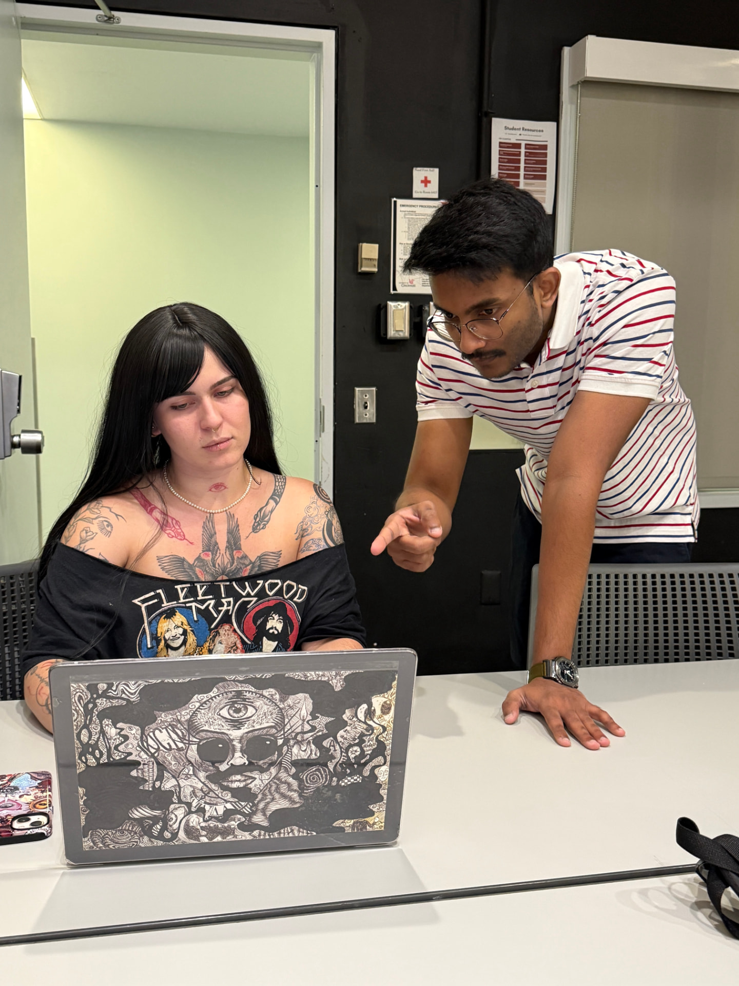 Walking a student through a technical issue on their laptop