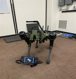 Quadruped with rigid guidance handle and operator controller